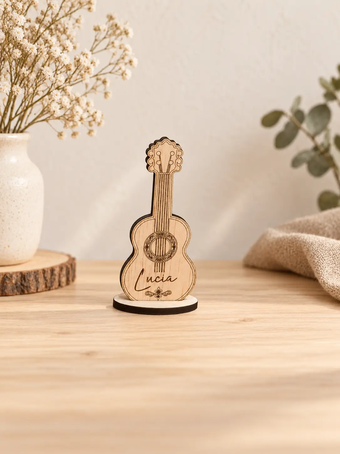 Marcasitio de madera en forma de guitarra con nombre grabado y peana redonda